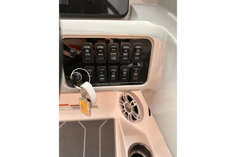 Slide: The Image of Control panel of 2020 Regal LS2 Surf boat with switches and ignition key. - 19
