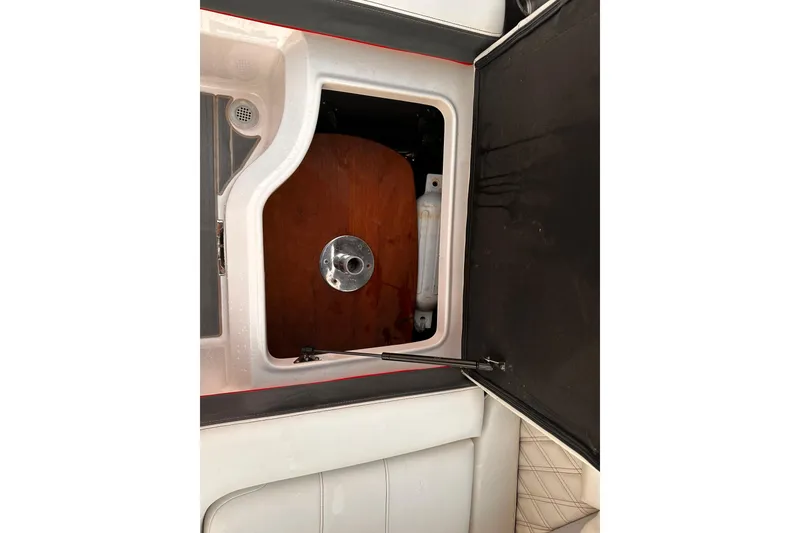 Slide: The Image of 2020 Regal LS2 Surf boat storage compartment with open hatch. - 21