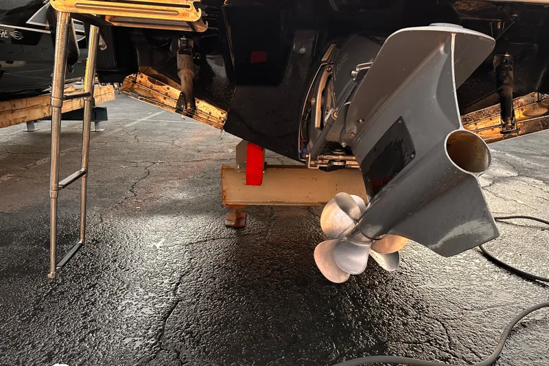 Slide: The Image of 2020 Regal LS2 Surf boat propeller and ladder on dry dock. - 22
