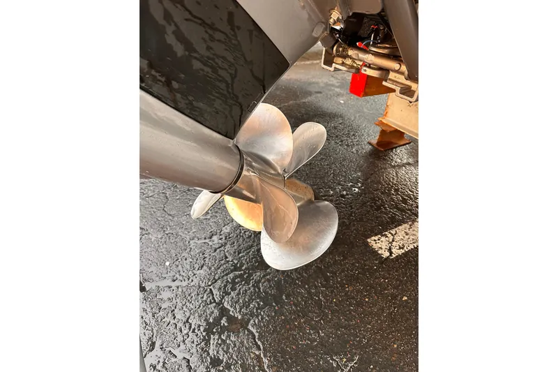 Slide: The Image of Propeller of 2020 Regal LS2 Surf boat on wet pavement. - 24