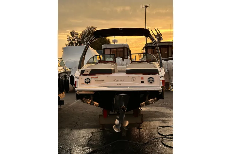 Slide: The Image of 2020 Regal LS2 Surf boat at sunset in a marina setting. - 29