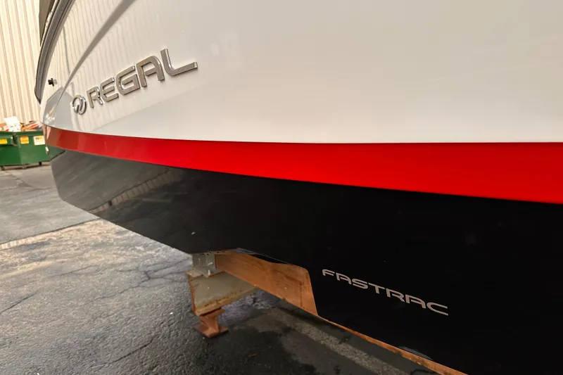 Slide: The Image of 2020 Regal LS2 Surf boat with Fastrac hull design, docked on a stand. - 34