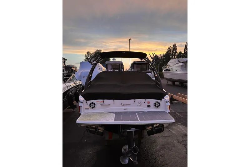 Slide: The Image of 2020 Regal LS2 Surf boat at sunset in a marina. - 37