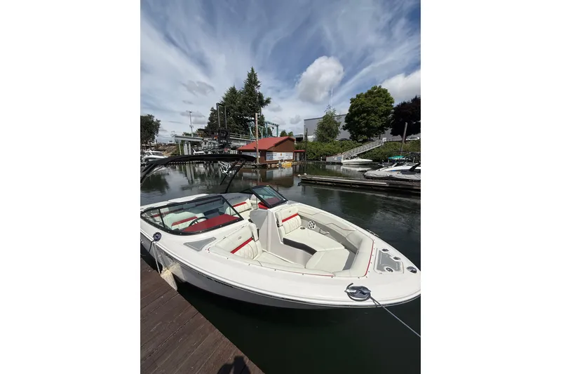 Slide: The Image of 2020 Regal LS2 Surf boat docked at a scenic marina under a partly cloudy sky. - 3
