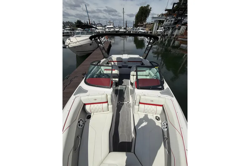 Slide: The Image of 2020 Regal LS2 Surf boat docked, featuring luxurious seating and sleek design. - 18