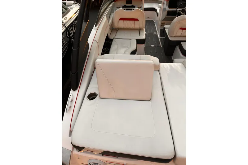 Slide: The Image of 2020 Regal LS2 Surf boat interior with beige seating and cup holder. - 6