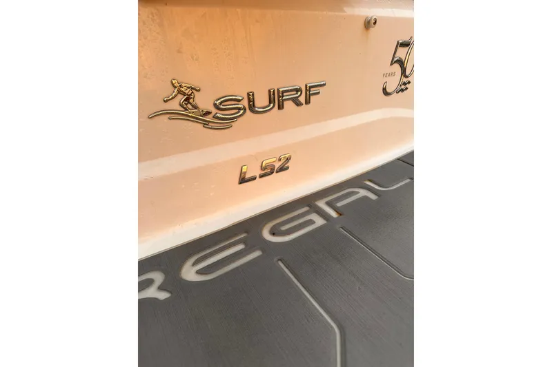 Slide: The Image of 2020 Regal LS2 Surf boat branding and logo details. - 8