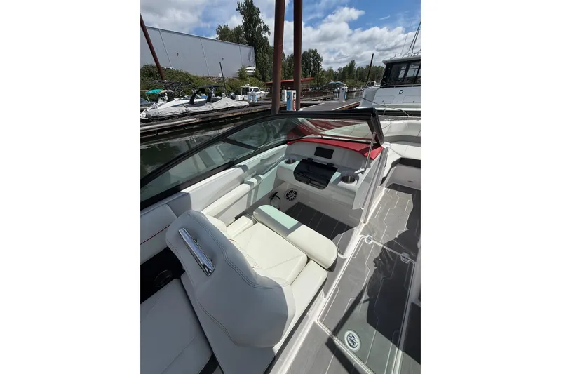 Slide: The Image of 2020 Regal LS2 Surf boat interior with white seating and modern dashboard. - 11