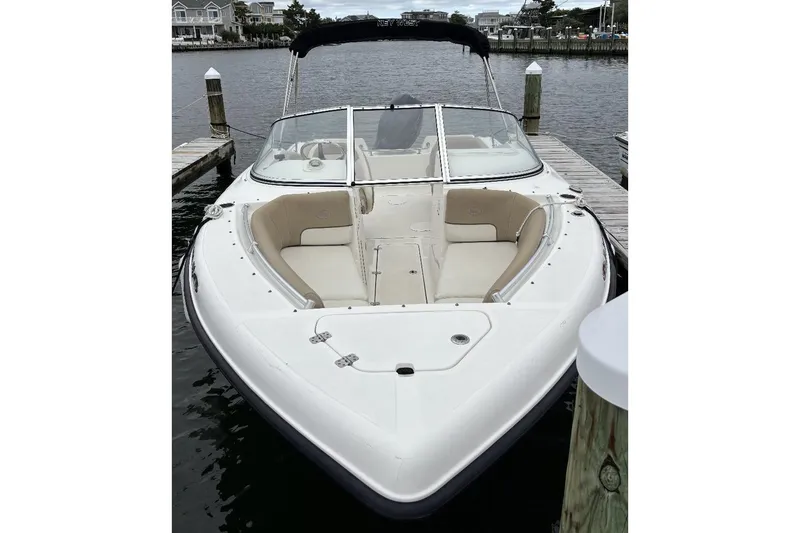 Slide: The Image of 2014 Key West 211 Dual Console boat docked at marina, featuring spacious seating. - 12
