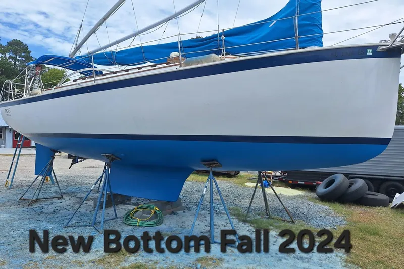 Slide: The Image of 1987 Nonsuch 30 Ultra sailboat on stands, scheduled for new bottom in Fall 2024. - 10