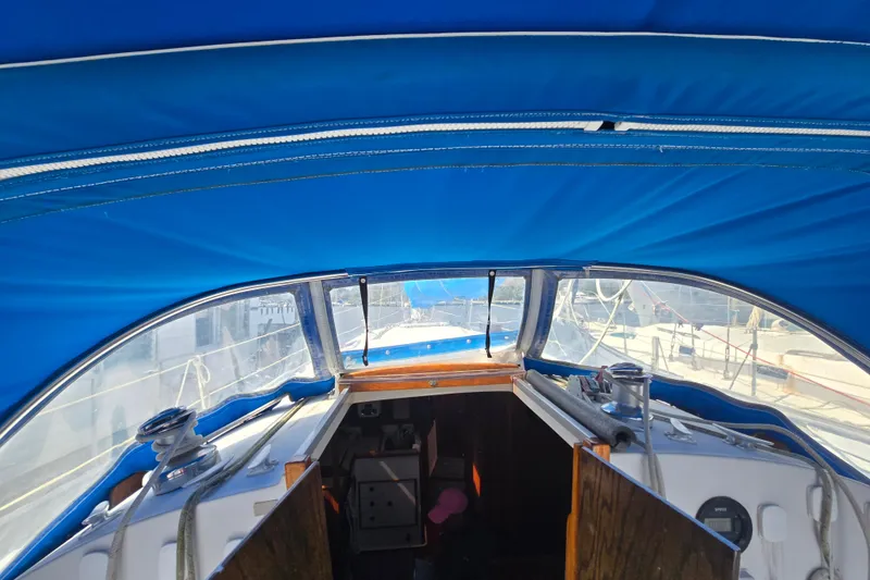Slide: The Image of Interior view of 1987 Nonsuch 30 Ultra sailboat with blue canopy and open cabin. - 19