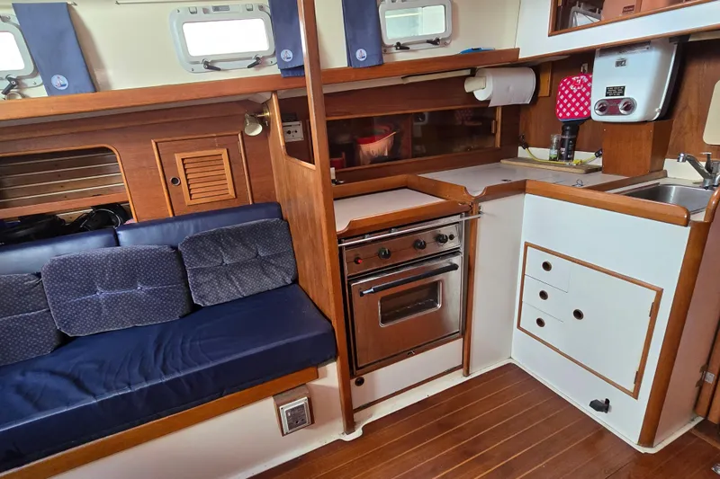 Slide: The Image of Interior of a 1987 Nonsuch 30 Ultra sailboat with kitchen and seating area. - 22