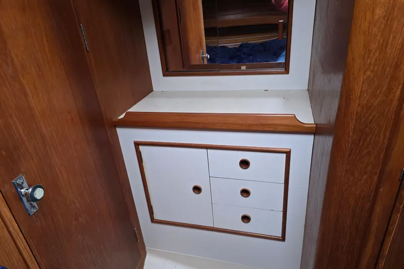 Slide: The Image of Interior of 1987 Nonsuch 30 Ultra sailboat with wooden cabinetry and mirror. - 25