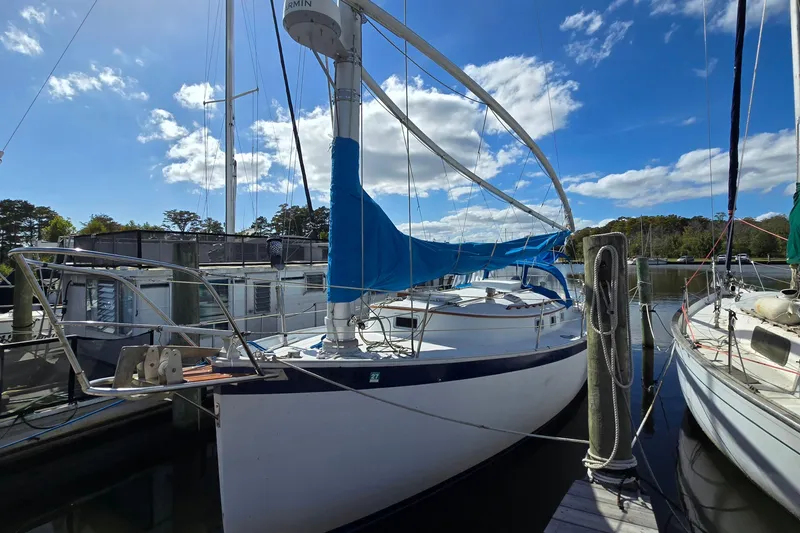 Slide: The Image of 1987 Nonsuch 30 Ultra sailboat docked under a clear blue sky. - 3