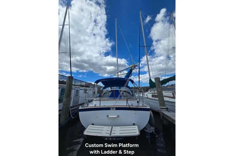 Slide: The Image of 1987 Nonsuch 30 Ultra sailboat with custom swim platform, ladder, and step at dock. - 37