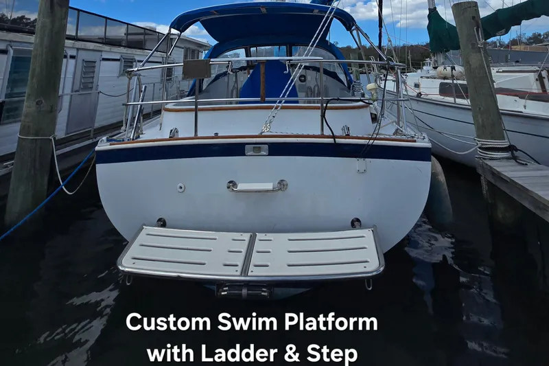 Slide: The Image of 1987 Nonsuch 30 Ultra with custom swim platform, ladder, and step at dock. - 6