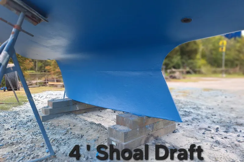 Slide: The Image of 1987 Nonsuch 30 Ultra sailboat with 4-foot shoal draft, blue hull on stands. - 9