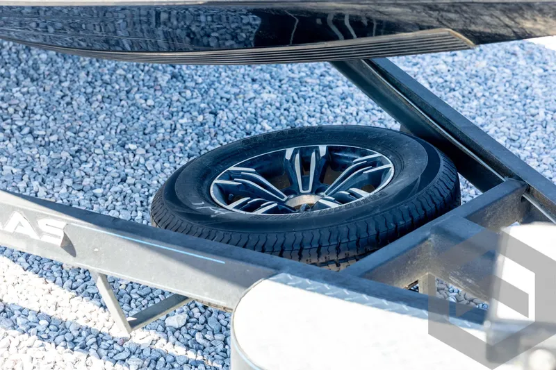 Slide: The Image of 2023 Caymas CX19 boat on trailer, featuring sleek design and powerful outboard motor. - 12