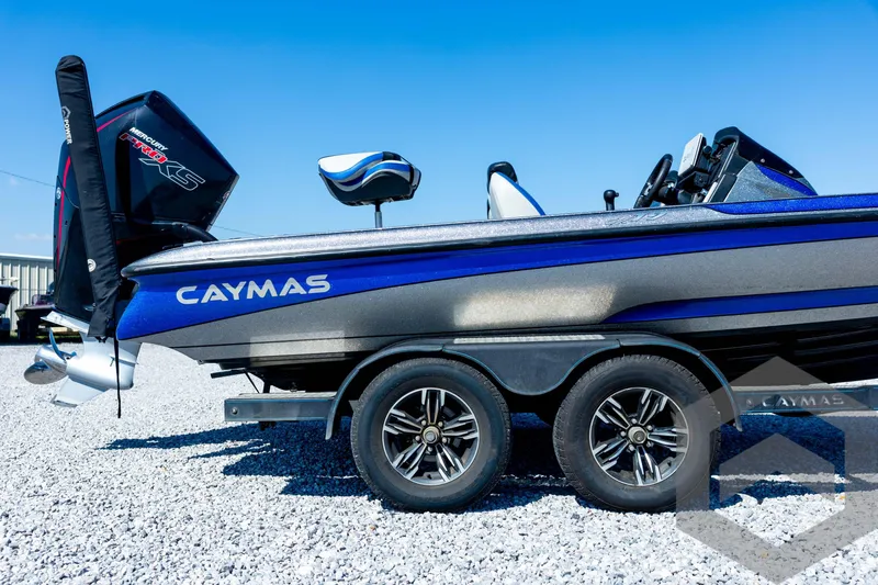 Slide: The Image of 2023 Caymas CX19 boat on trailer, featuring Garmin equipment, parked on gravel. - 14