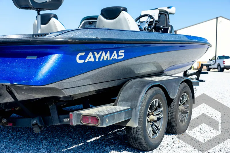 Slide: The Image of 2023 Caymas CX19 boat with powerful outboard motor on a trailer. - 17