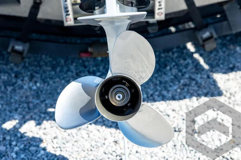 Slide: The Image of 2023 Caymas CX19 boat with blue accents on a trailer, parked on gravel. - 20