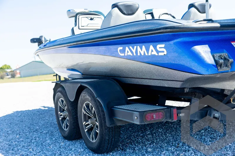 Slide: The Image of 2023 Caymas CX19 boat with Mercury Pro XS engine, featuring sleek blue design. - 26