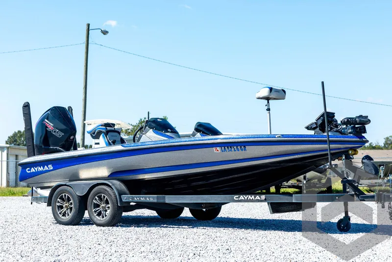 Slide: The Image of 2023 Caymas CX19 boat on trailer, featuring Garmin equipment, parked outdoors. - 3