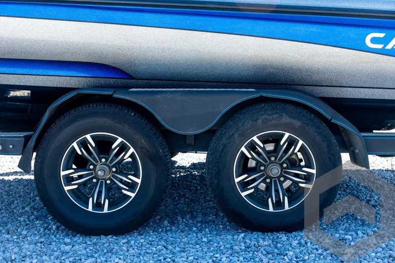 Slide: The Image of 2023 Caymas CX19 boat deck with Garmin equipment, featuring a spacious, carpeted layout. - 33