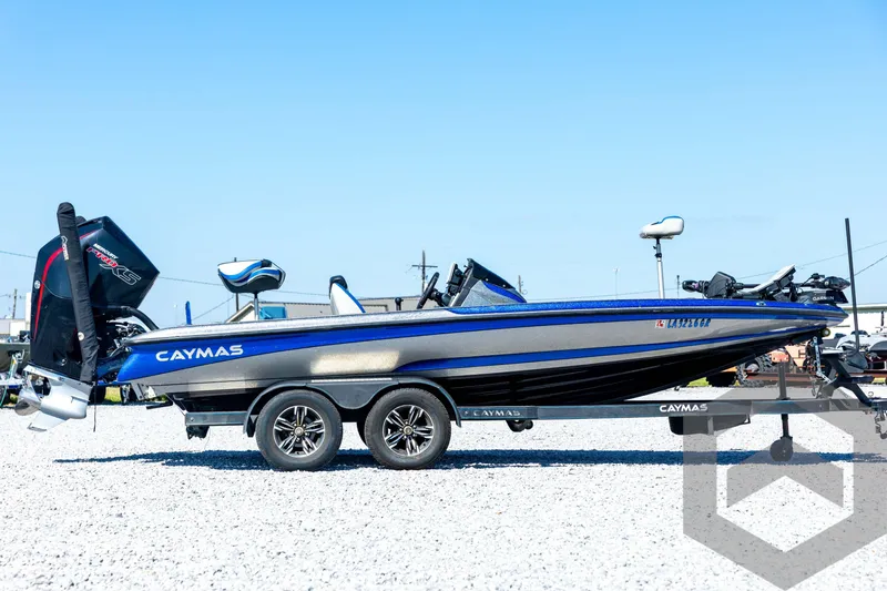 Slide: The Image of 2023 Caymas CX19 boat on trailer, blue and gray design, parked outdoors. - 4