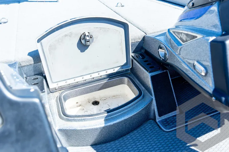 Slide: The Image of 2023 Caymas CX19 boat deck with storage compartments and carpeted surface. - 53