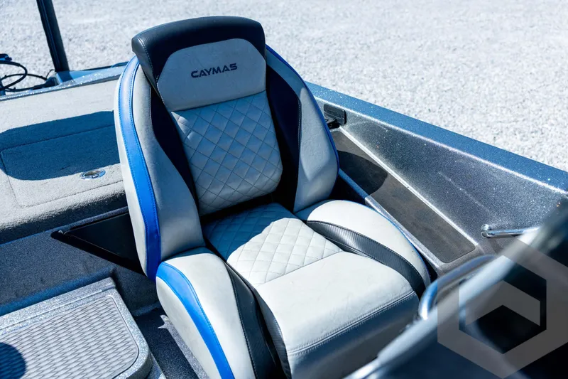 Slide: The Image of 2023 Caymas CX19 boat storage compartments, open and empty, with gray interior. - 55