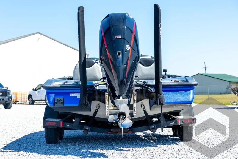 Slide: The Image of 2023 Caymas CX19 boat on trailer, parked near a large truck. - 6