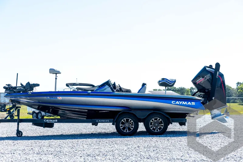 Slide: The Image of 2023 Caymas CX19 boat on trailer, blue and gray design, parked on gravel. - 8