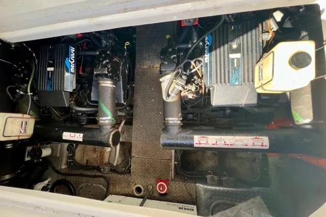 Slide: The Image of Engine compartment of a 1995 Regal Commodore 400 boat, featuring dual MerCruiser engines. - 14