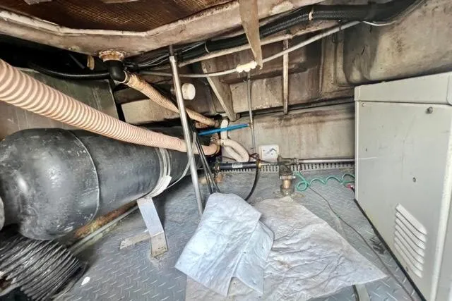 Slide: The Image of Engine compartment of a 1995 Regal Commodore 400 boat, showing pipes and machinery. - 17