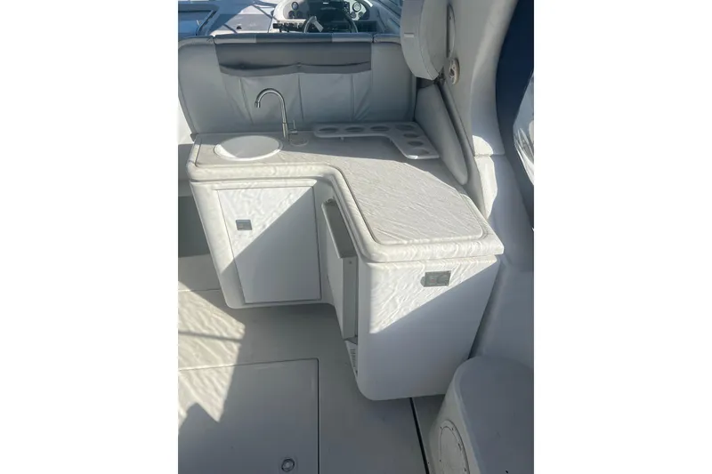 Slide: The Image of Interior of 1995 Regal Commodore 400 boat featuring a compact kitchenette with sink. - 21