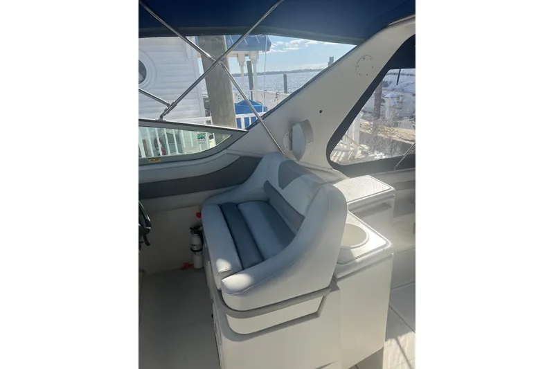 Slide: The Image of Interior of a 1995 Regal Commodore 400 boat with cushioned seating and ocean view. - 24