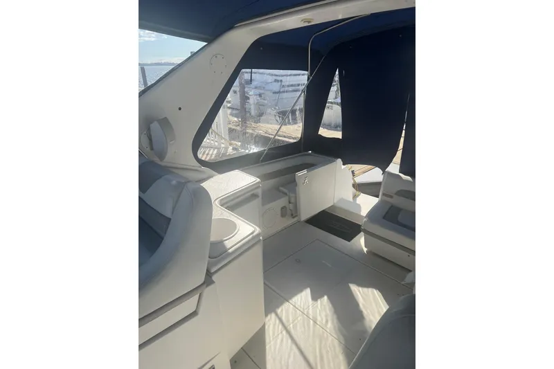 Slide: The Image of Interior view of a 1995 Regal Commodore 400 boat with seating and windows. - 25