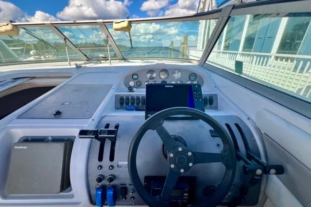 Slide: The Image of Cockpit of 1995 Regal Commodore 400 boat with steering wheel and navigation instruments. - 3