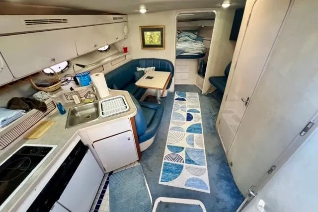 Slide: The Image of Interior of 1995 Regal Commodore 400 yacht with kitchen and seating area. - 4