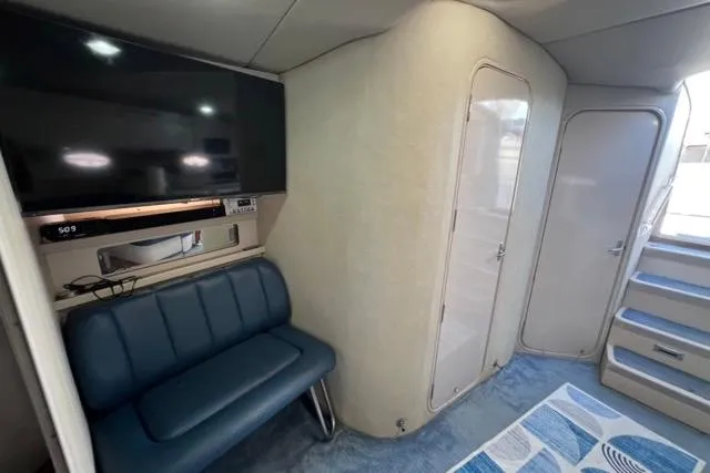 Slide: The Image of Interior of 1995 Regal Commodore 400 yacht with seating, TV, and stairs. - 6