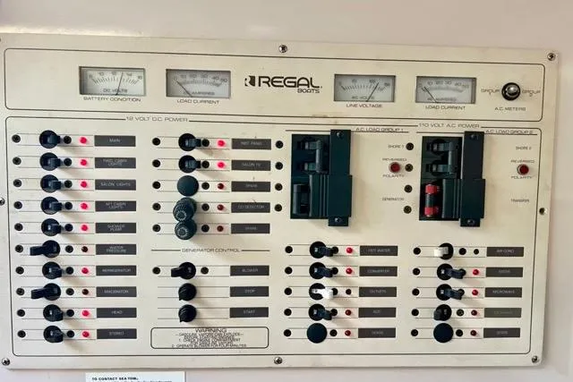 Slide: The Image of Control panel of a 1995 Regal Commodore 400 boat with various switches and meters. - 8
