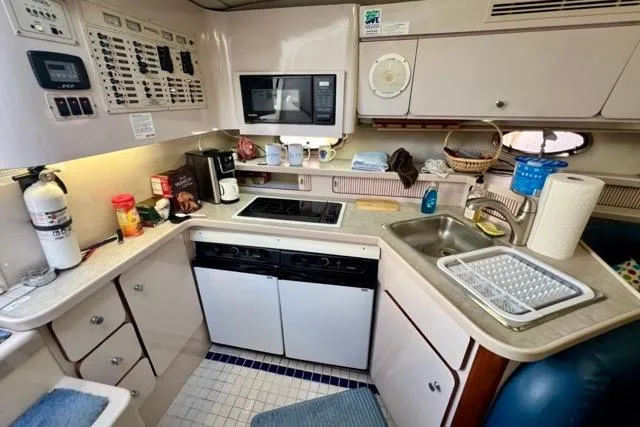 Slide: The Image of Compact kitchen in a 1995 Regal Commodore 400 yacht with modern amenities. - 9