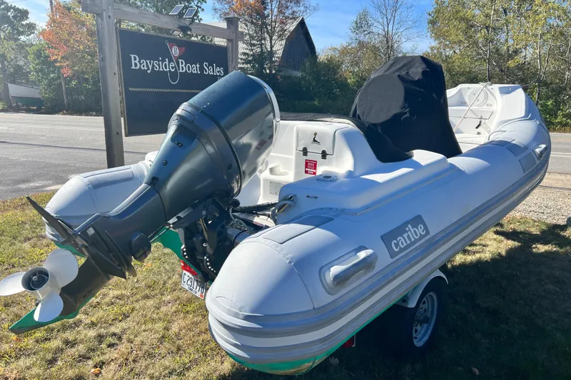 Slide: The Image of 2007 Caribe 15DL inflatable boat at Bayside Boat Sales, featuring an outboard motor. - 18