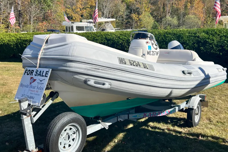 Slide: The Image of 2007 Caribe 15DL inflatable boat for sale on trailer, displayed outdoors. - 2
