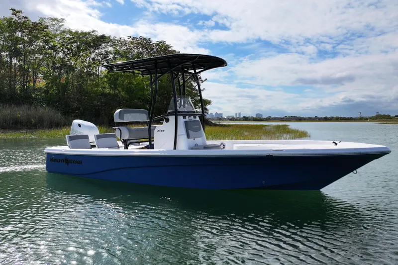 Slide: The Image of 2026 NauticStar 214 Bay boat on calm water, featuring sleek design and modern amenities. - 12