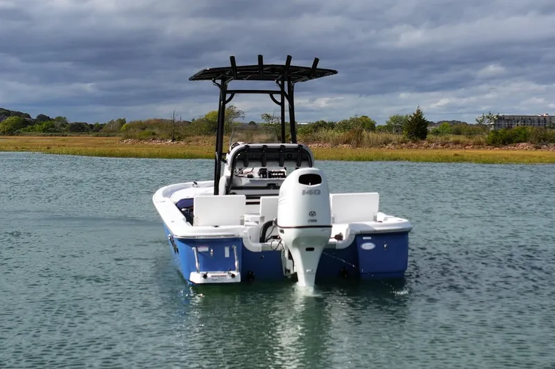Slide: The Image of 2026 NauticStar 214 Bay boat on calm water under cloudy sky. - 6
