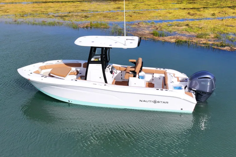 Slide: The Image of 2026 NauticStar 242 Offshore boat on calm water, featuring sleek design and modern amenities. - 12