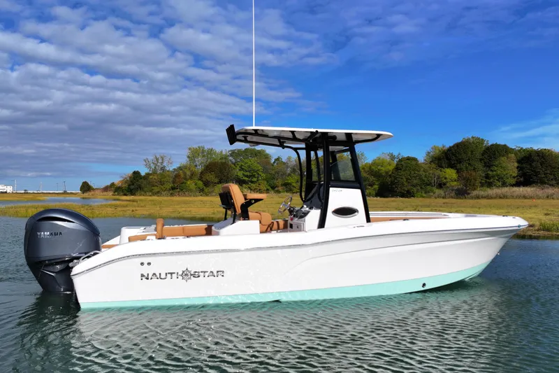 Slide: The Image of 2026 NauticStar 242 Offshore boat on calm water, featuring sleek design and Yamaha engine. - 3