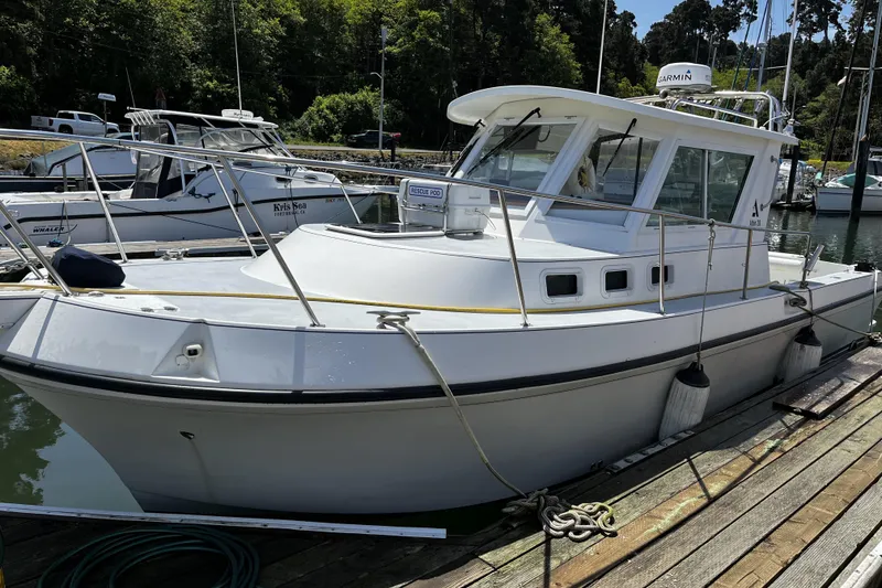 Slide: The Image of 2005 Albin 28 Tournament Express boat docked at marina, surrounded by trees. - 0
